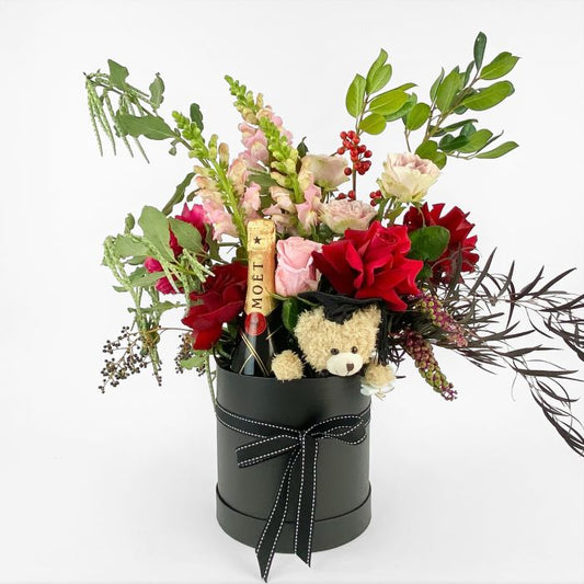 Floral arrangement in a black box with a graduation teddy bear flowers gift florist melbourne
