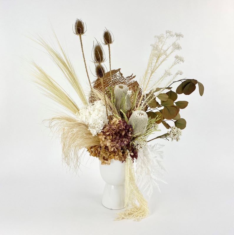 Decorative floral arrangement with dried elements in a white vase same day florist delivery melbourne