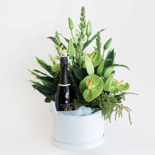 Bottle of champagne in a bouquet of flowers with yellow sparkling brut hamper best florist melbourne