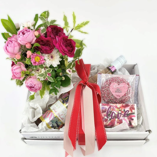 Bouquet of flowers with a box containing a bottle of wine, Chocolate, soap just because florist melbourne