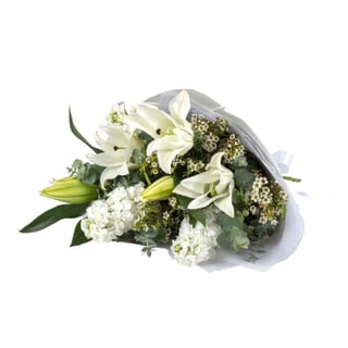 Classic white bouquet with white oriental lilies, stock and seasonal white fillers with lush foliage base. Melbourne & Australia wide Same day delivery