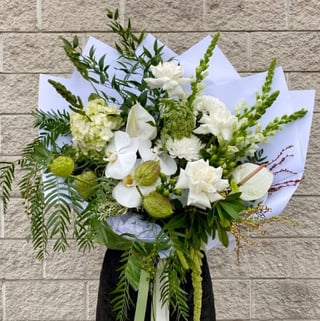 Luxe bouquet featuring roses, phalaenopsis orchids, anthuriums, queen annes lace, swan fruit and seasonals to compliment. Melbourne Metro delivery only.