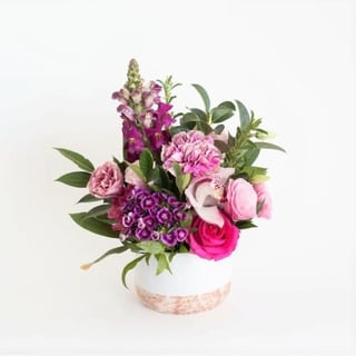 Perfect flower gift idea - small pretty in pink seasonal ceramic arrangement with mixed pink flowers.