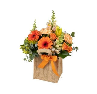 Mixed hessian bag arrangement in oranges featuring snapdragons, mini gerberas, spray roses and carnations. Same day delivery in Melbourne and Australia