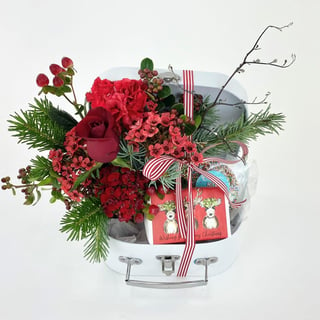 Christmas themed red and green flower arrangement with freckled chocolates and Huxter Merry Christmas hand soap