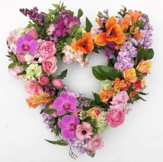 Colourful wreath in lilacs, pinks and oranges, available in round or heart shaped wreath. Melbourne delivery only. 1- 2 days notice.