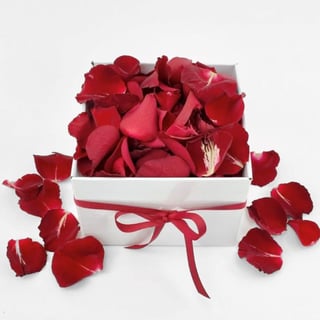 Box filled with loose rose petals for decoration