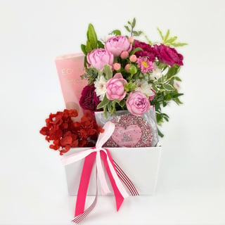 Gift box filled with Ecoya candle or diffuser, Chocolatier chocolate, pretty pink florals in tin pot.