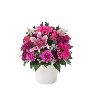 Gorgeous mix of bright pink gerberas, carnations, oriental lilies, roses and orchids in ceramic vase. Same day delivery in Melbourne.