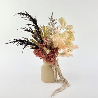 Textured vase featuring dried and preserved flowers featuring banksia, hydrangea, lunaria, palm, billy buttons, bunny tails and ming.
