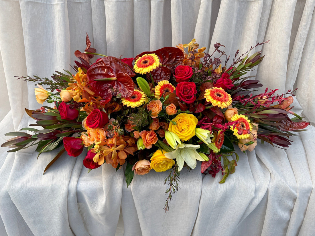 Custom Coffin Flowers Melbourne Featuring Rich Reds, Oranges & Golden Yellows