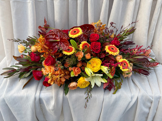 Custom Coffin Flowers Melbourne Featuring Rich Reds, Oranges & Golden Yellows