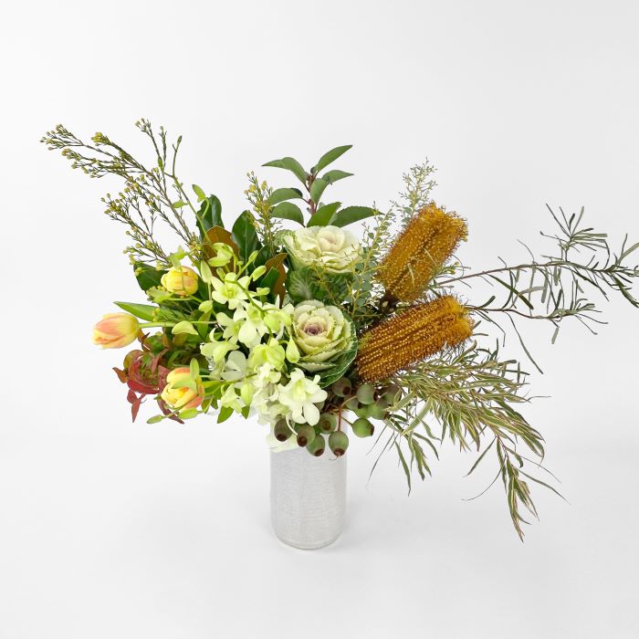Ceramic vase arrangement with bouquet filled with tulips, banksias, kale. orchids and textured foliage to suit