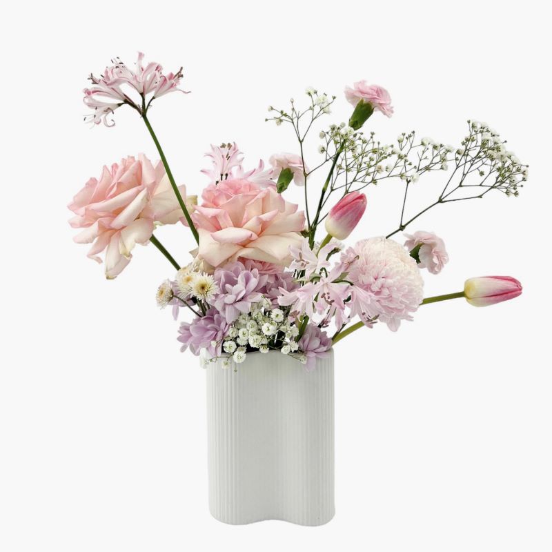 Elsa - Soft pink roses, tulips, chrysanthemums, babies breath and seasonal flowers with infinity vase.