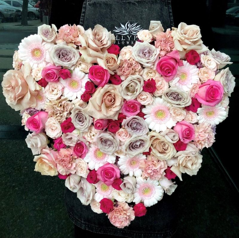 Love heart shaped flower arrangement featuring roses, gerberas and sim carnations. Advance order required for Melbourne delivery.
