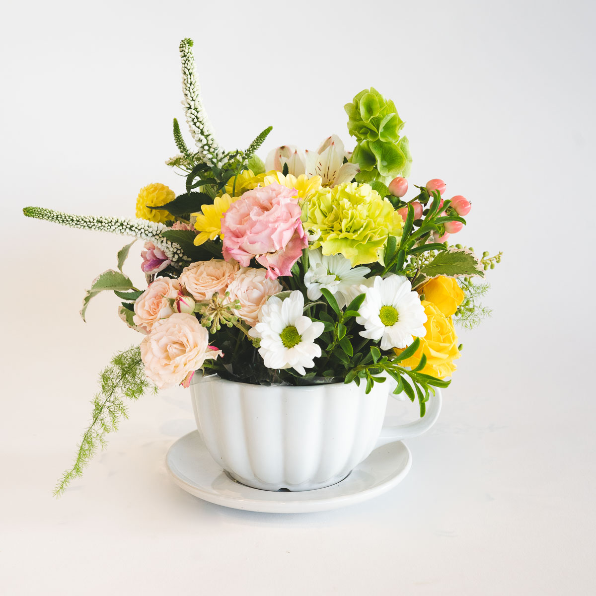 Flower arrangement in lemon and lime seasonal flowers to include some roses, chrysanthemums and sims.