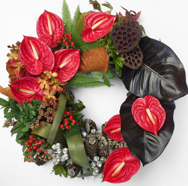Flower wreath featuring red anthuriums, orange orchids, red hypericums and deep tropical leaves. Available for Melbourne delivery only. 1-2 days notice required.