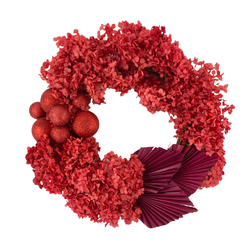 Red Christmas door wreath, featuring preserved red hydrangeas, red Christmas baubles and palm spades.