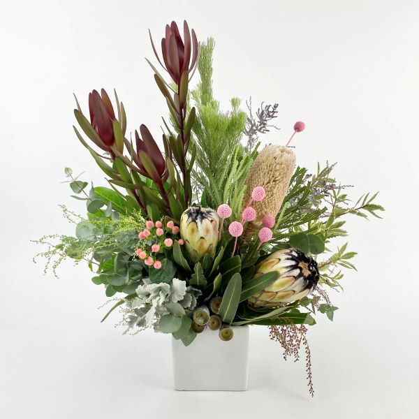 Ceramic arrangement with native proteas, banksia, billy buttons, leucadendrons and gum.