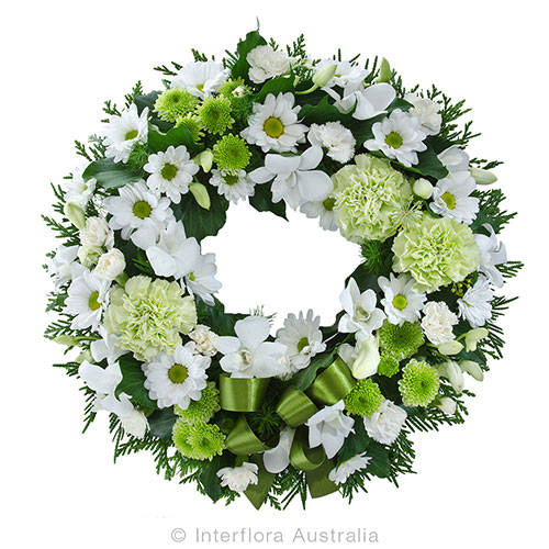 White and green funeral flower wreath filled with green and white chrysanthemums, green sim carnations and white singapore orchids. Melbourne delivery.