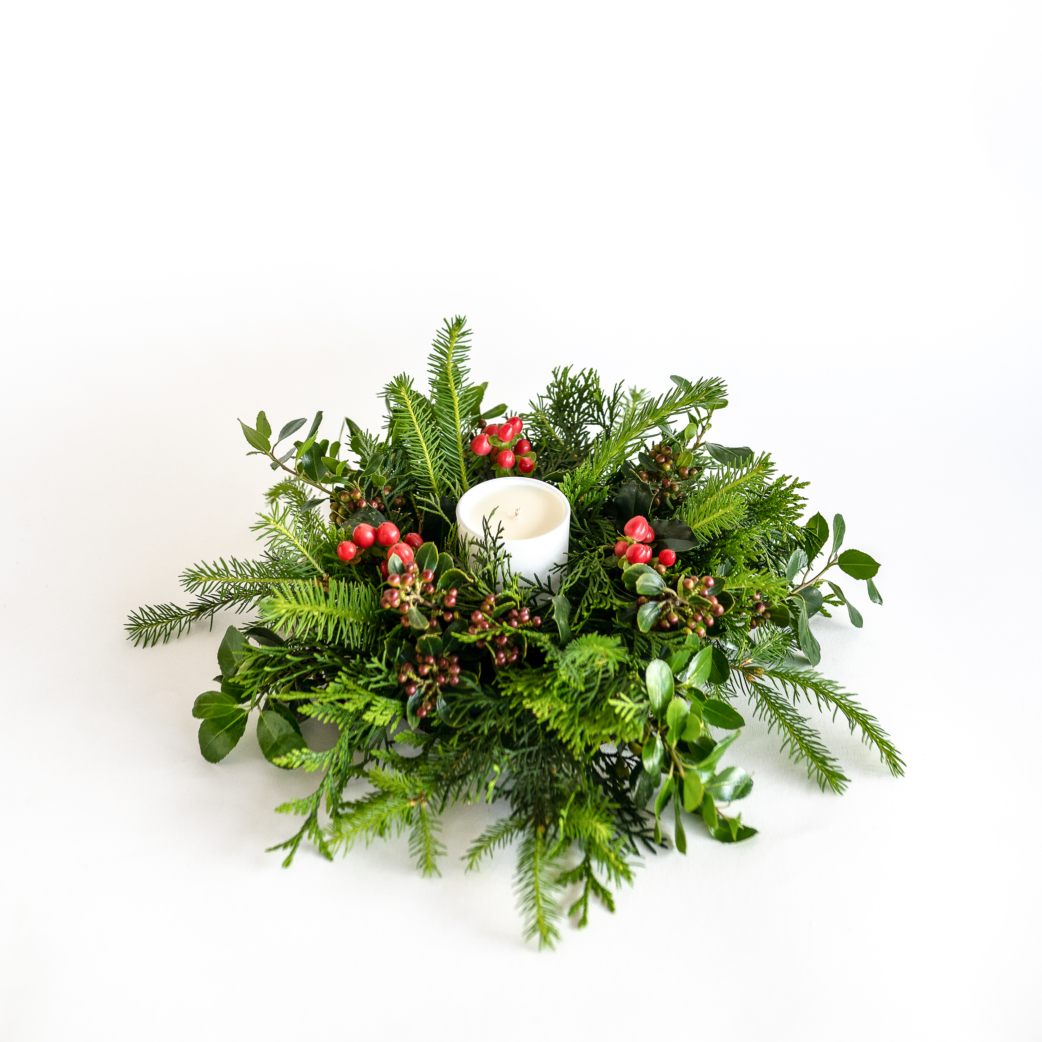 Fresh pine foliage christmas wreath with pine scented Ecoya candle.