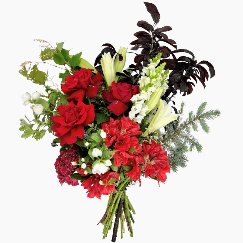 Fragrant November lilies, snapdragons, roses, and seasonals combined with christmas foliage.