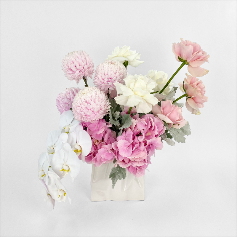 Light pink and white luxe bouquet in ceramic vase, featuring roses, hydrangea, disbuds and phalaenopsis orchid (tones may vary slightly upon availability)