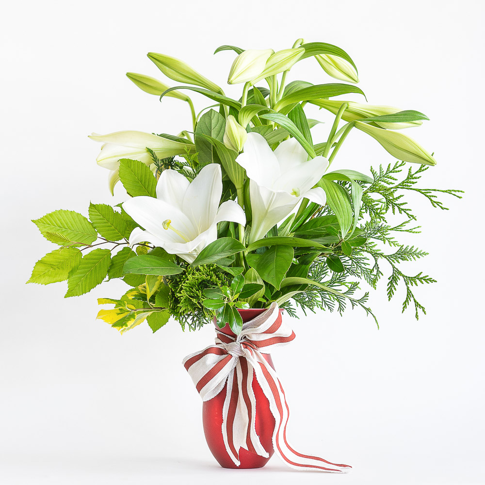 White christmas lily bouquet in white vase arrangement