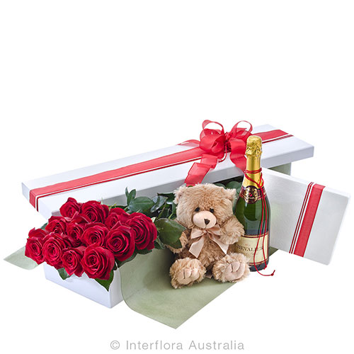 Twelve long stem red roses, champagne, chocolate and teddy bear.