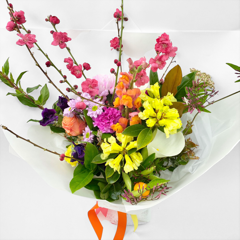 Bright and fun bouquet featuring a mix of rainbow coloured blossoms and seasonal flowers. Fragrant bouquet to uplift.