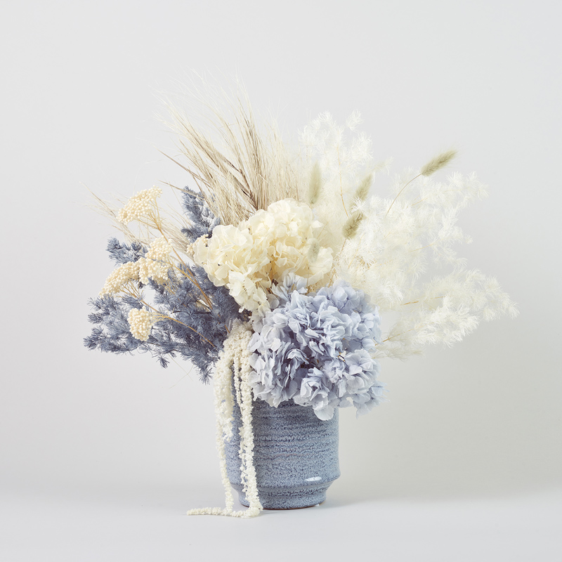 Stunning dried and preserved blue and white flower arrangement in blue ceramic vase. Melbourne Metro delivery only.