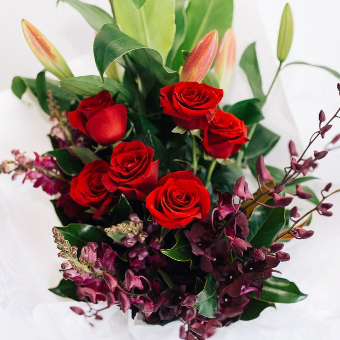 Leila - rich opulent bouquet of red roses, eggplant purple orchids, purple snapdragons and pink oriental lilies, Melbourne delivery only.