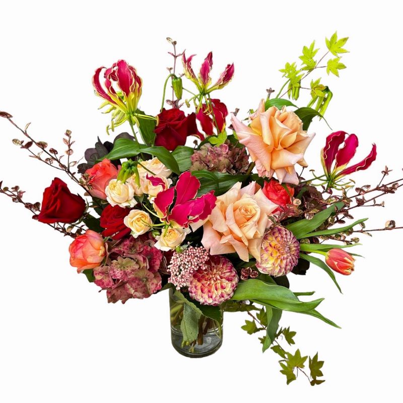 Josie - Autumn themed vase (optional) arrangement with red and orange combination filled with roses, dahlias hydrangea and gloriosa lily.